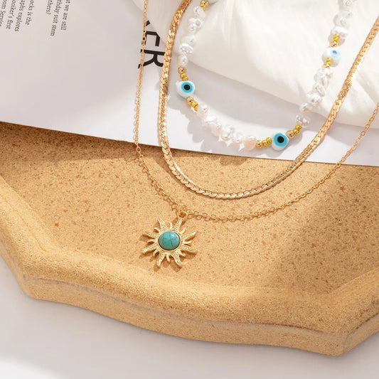 Gold Necklace Set with Pearl Choker, Evil Eye, and Sun Pendants
 - ModishWorld