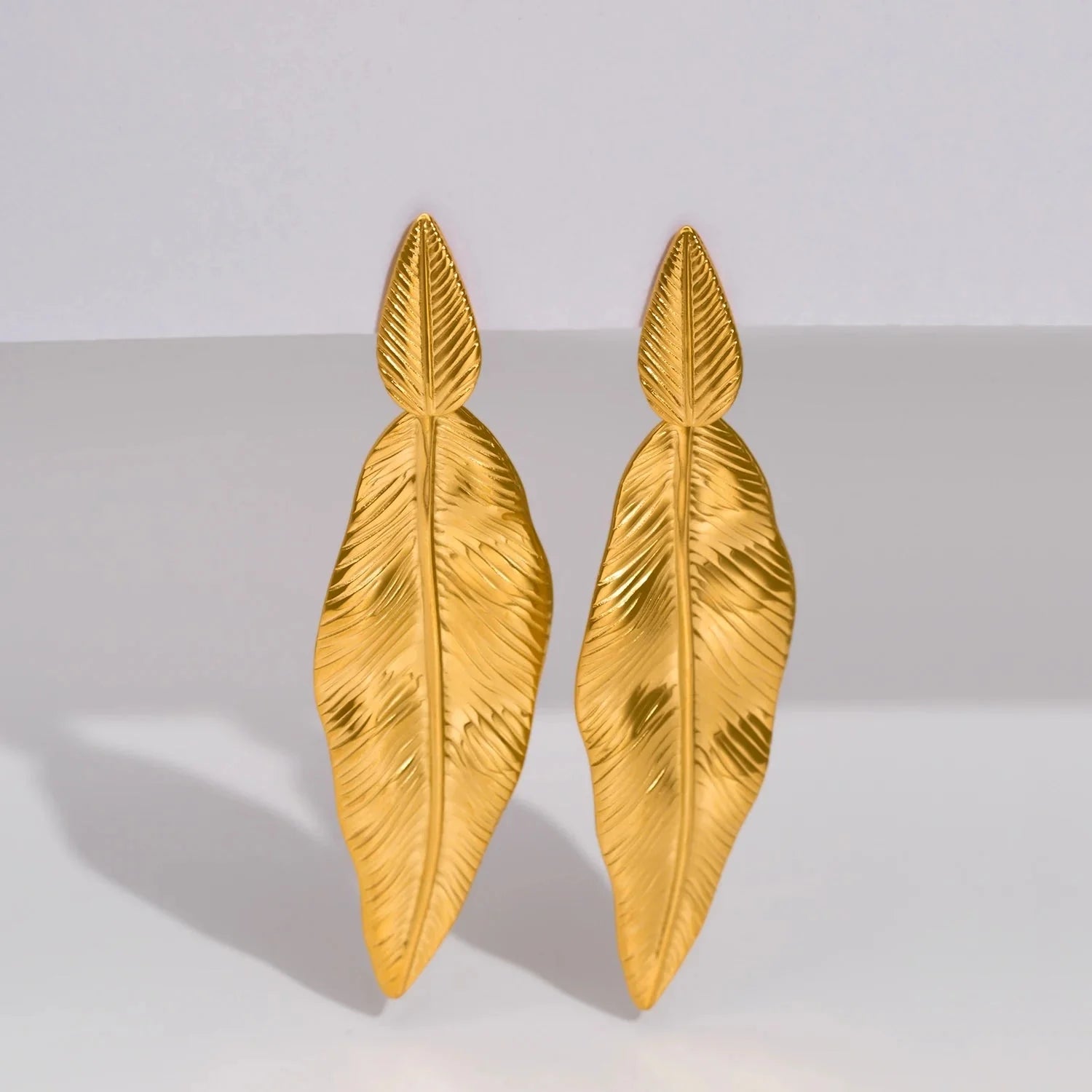 Luxury Gold Feather Earrings: High-End Statement Piece
 - ModishWorld